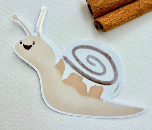 Snail sticker with a cinnamon bun shell with cinnamon sticks in the background